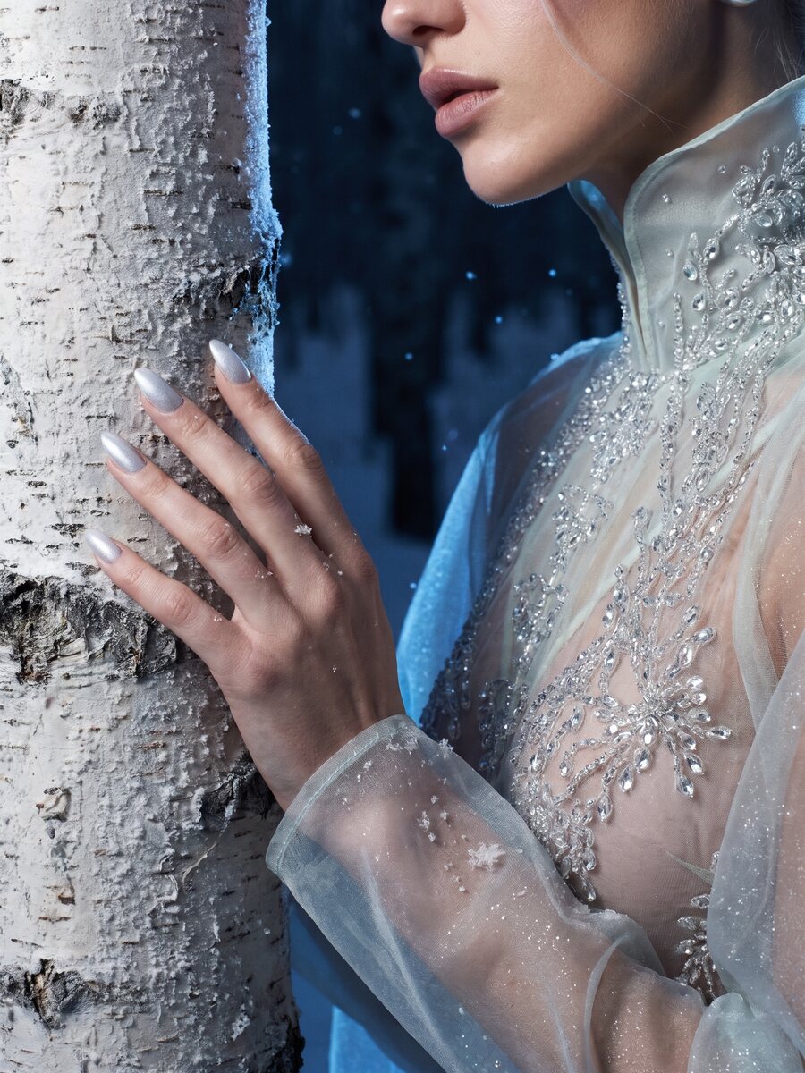 Detail of crystal embroidery and hand on a frosted birch